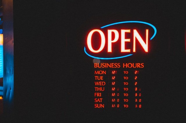 Sign with business hours for a restaurant